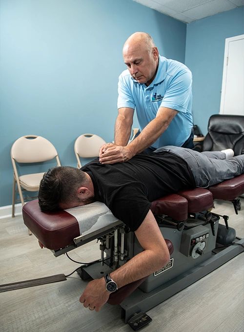 Chiropractor Baltimore MD Mark Stutman Assessing Patients Back